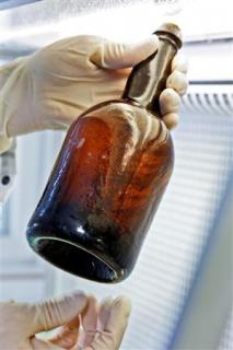 A bottle of beer found in an 1840s shipwreck near Finland is seen in a handout photo. Finnish researchers say they may be able to recreate beer from the 1840s after finding living bacteria in beer from a shipwreck near Aland islands. REUTERS/VTT/Handout